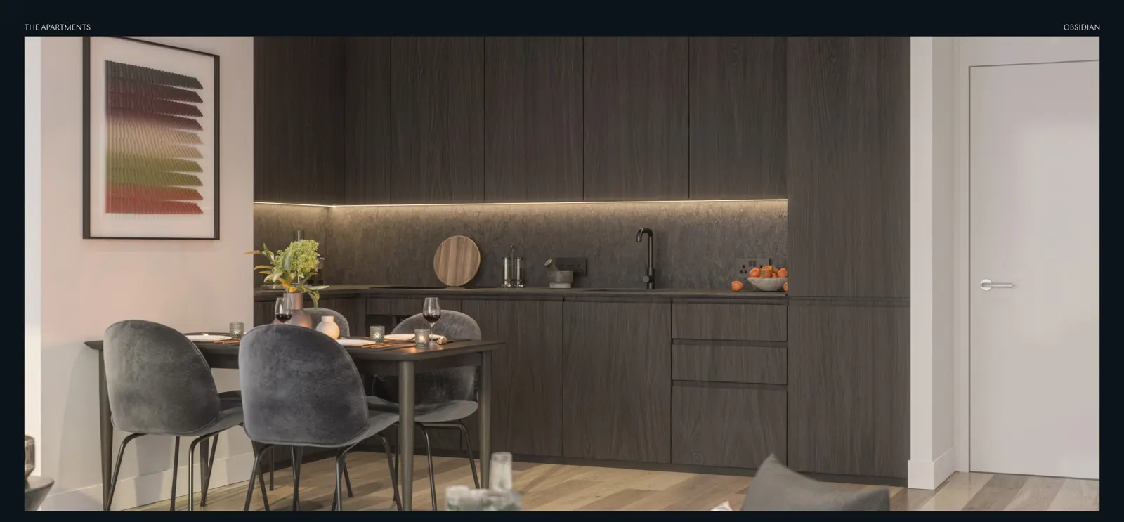 Dark-finish kitchen with dining table at Obsidian