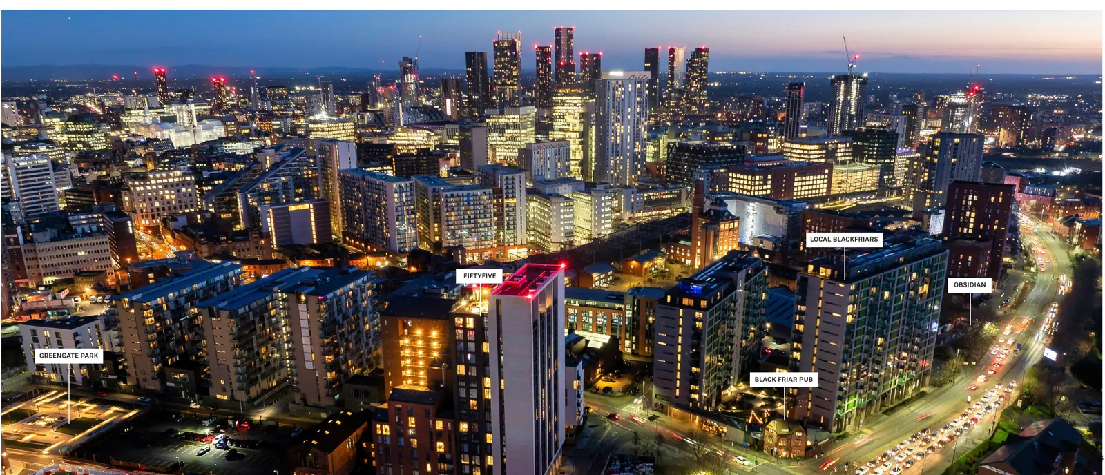 Manchester skyline at night with Obsidian's location marked